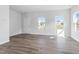 Spacious living room showcasing wood-look floors and lots of natural light from several windows at 157 Grove Township Way, Angier, NC 27501