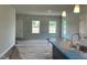 Open living space with recessed lighting, large windows, and a view into the dining area at 157 Grove Township Way, Angier, NC 27501