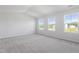 Spacious Primary bedroom features multiple windows providing ample natural light and a neutral carpet at 157 Grove Township Way, Angier, NC 27501