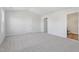 Neutral carpeted Primary bedroom with a door to an ensuite bathroom and plenty of natural light at 157 Grove Township Way, Angier, NC 27501