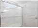 Modern shower featuring a glass enclosure and sleek fixtures next to a door at 157 Grove Township Way, Angier, NC 27501