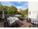 Landscaped backyard with brick patio and lush greenery provides a serene outdoor space at 1703 Happiness Hill Ln, Raleigh, NC 27614