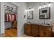 Bathroom featuring double vanity, black countertops and walk-in closet at 1703 Happiness Hill Ln, Raleigh, NC 27614
