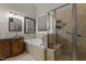 Luxurious bathroom with a soaking tub, glass shower, and custom vanity at 1703 Happiness Hill Ln, Raleigh, NC 27614