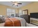 Comfortable bedroom featuring large windows, ceiling fan, and a work desk at 1703 Happiness Hill Ln, Raleigh, NC 27614