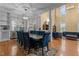Elegant dining room with a large table, blue chairs, hardwood floors and bright sunlight at 1703 Happiness Hill Ln, Raleigh, NC 27614