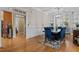 Elegant dining room with wood floors, blue chairs and ample natural light at 1703 Happiness Hill Ln, Raleigh, NC 27614