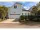 Light blue house with a two-car garage, driveway, and green yard features a bright sunny day at 1703 Happiness Hill Ln, Raleigh, NC 27614