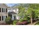 A bright two-story home showcasing detailed trim, arched windows, and manicured landscaping at 1703 Happiness Hill Ln, Raleigh, NC 27614