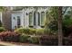 Charming two-story home with arched windows, shutters, and lush landscaping at 1703 Happiness Hill Ln, Raleigh, NC 27614
