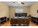 Inviting home office space featuring hardwood floors, a ceiling fan and natural light from the window at 1703 Happiness Hill Ln, Raleigh, NC 27614