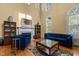 Bright living room boasts high ceilings, a fireplace, and stylish blue furnishings at 1703 Happiness Hill Ln, Raleigh, NC 27614