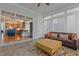 Cozy sunroom features a sofa, coffee table, and leads to the kitchen area at 1703 Happiness Hill Ln, Raleigh, NC 27614