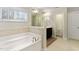 Bathroom features tile flooring, bright lighting, a tub and a vanity at 1726 Rapids Ct, Franklinton, NC 27525
