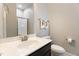 Well-lit bathroom featuring a vanity with a sink, mirror, toilet, and walk-in shower at 1726 Rapids Ct, Franklinton, NC 27525