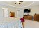 Open bedroom boasts a tray ceiling, natural light, plush carpet, and ample storage at 1726 Rapids Ct, Franklinton, NC 27525