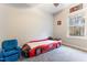 Bedroom featuring a race car bed, soft carpeting, and a comfortable blue armchair at 1726 Rapids Ct, Franklinton, NC 27525