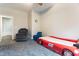 Bedroom featuring a race car bed, soft carpeting, and a comfortable grey armchair at 1726 Rapids Ct, Franklinton, NC 27525