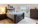 Bedroom features a large window, with wood furnishings and neutral carpet at 1726 Rapids Ct, Franklinton, NC 27525