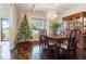 Formal dining room with hardwood floors, chandelier, and a Christmas tree at 1726 Rapids Ct, Franklinton, NC 27525