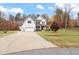 Two-story house with a gray roof and beige siding, a two-car garage and a landscaped yard at 1726 Rapids Ct, Franklinton, NC 27525