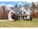 Two-story house with a gray roof, beige siding, and a covered porch at 1726 Rapids Ct, Franklinton, NC 27525
