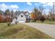 Two-story house with a gray roof, beige siding, and a large driveway. Landscaped yard with trees at 1726 Rapids Ct, Franklinton, NC 27525