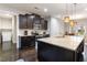 Well-equipped kitchen featuring dark wood cabinets, granite countertops, and stainless steel appliances at 1726 Rapids Ct, Franklinton, NC 27525