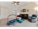Cozy living room features plush seating, neutral walls, and a ceiling fan for added comfort at 1726 Rapids Ct, Franklinton, NC 27525