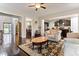 Open living room with hardwood floors, a fireplace and views into kitchen and dining areas at 1726 Rapids Ct, Franklinton, NC 27525
