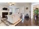 Spacious living room featuring hardwood floors, a fireplace, and ample natural light at 1726 Rapids Ct, Franklinton, NC 27525
