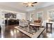Living room with hardwood floors, a view of the kitchen, and two armchairs at 1726 Rapids Ct, Franklinton, NC 27525