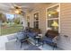 Covered porch with wicker furniture and ceiling fan at 1726 Rapids Ct, Franklinton, NC 27525