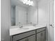 Bright bathroom featuring a double sink vanity with gray cabinets, a wide mirror, and modern lighting at 173 Grove Township Way, Angier, NC 27501