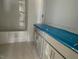 A bathroom with a tub and shower combo and new cabinets with modern hardware at 173 Grove Township Way, Angier, NC 27501