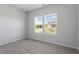 Bright bedroom featuring two windows and neutral carpet at 173 Grove Township Way, Angier, NC 27501