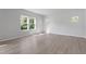 Bright, empty bedroom with neutral walls, wood floors, and large windows with natural light at 173 Grove Township Way, Angier, NC 27501