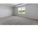 Spacious bedroom with neutral carpet and two windows allowing natural light at 173 Grove Township Way, Angier, NC 27501