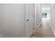 Bright hallway featuring modern wood flooring and neutral paint, leading to an open living space at 173 Grove Township Way, Angier, NC 27501