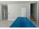 View of kitchen island and open layout with lots of light and unfinished staircase at 173 Grove Township Way, Angier, NC 27501