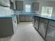 Spacious kitchen featuring gray cabinets, stone countertops, and stainless steel appliances at 173 Grove Township Way, Angier, NC 27501