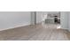 Spacious, open-concept living area with light wood floors, neutral paint, and access to the modern kitchen at 173 Grove Township Way, Angier, NC 27501