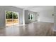 Bright living room with wood floors, neutral walls, multiple windows, and access to the outdoor deck at 173 Grove Township Way, Angier, NC 27501
