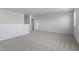 Large, bright loft area with neutral carpet and access to other rooms at 173 Grove Township Way, Angier, NC 27501