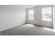 Bright bedroom featuring two large windows and neutral colored carpet at 178 Grove Township Way, Angier, NC 27501