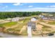 Two-story home with white siding, black shutters, concrete driveway, and landscaping in a new home community at 178 Grove Township Way, Angier, NC 27501