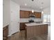 Open kitchen features brown cabinets, white subway tile backsplash, and an island with pendant lighting at 178 Grove Township Way, Angier, NC 27501