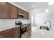 Spacious kitchen featuring stainless steel appliances, white countertops, and brown cabinetry at 178 Grove Township Way, Angier, NC 27501