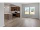Modern kitchen open to the living room with wood flooring and stainless steel appliances at 178 Grove Township Way, Angier, NC 27501
