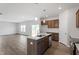 Open kitchen with island, wood floors, and seamless flow to the living room at 178 Grove Township Way, Angier, NC 27501